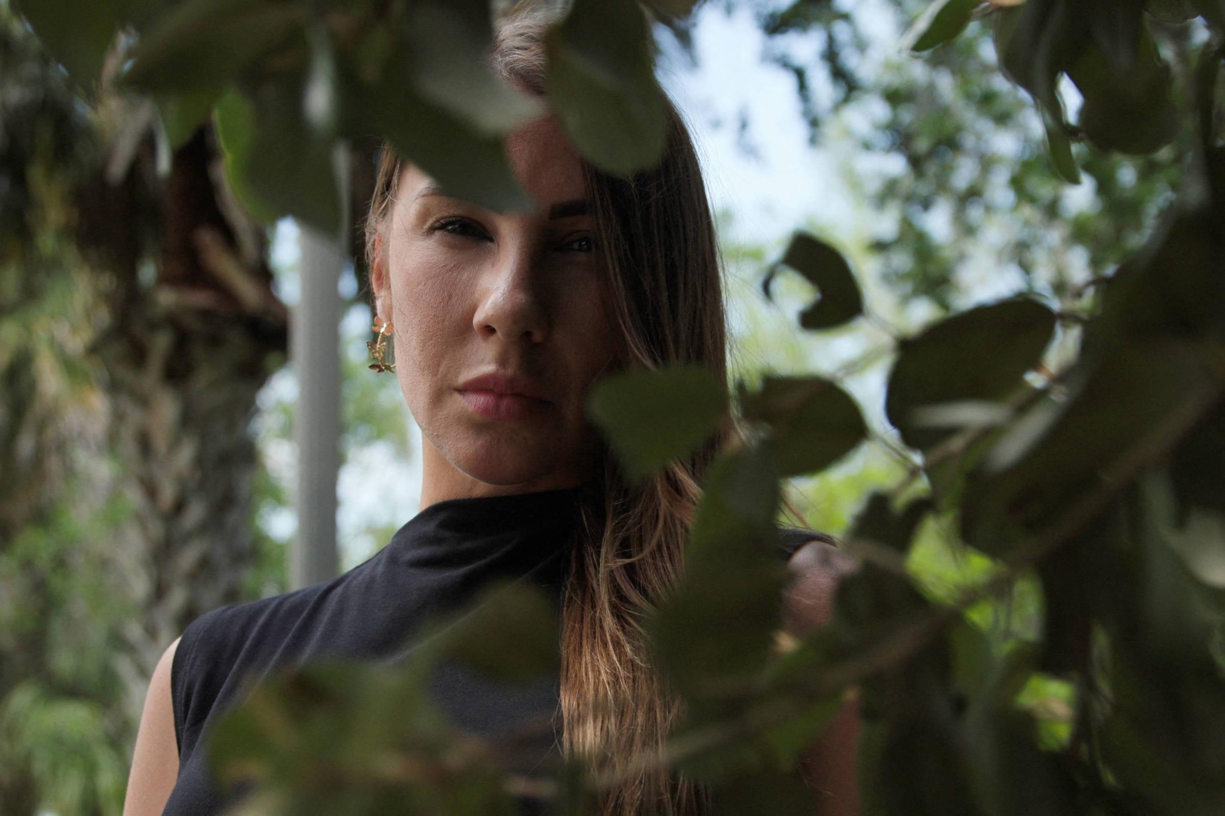 Brazilian woman who accused Epstein says she has started sleeping with a gun after threats; 'I'm paranoid'.