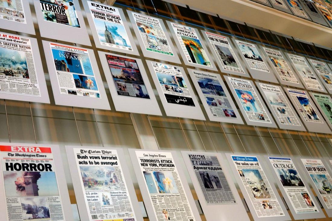 A wall of newspaper front pages from 12 September 2001 on display at the Newseum, Washington DC: TERROR, HORROR, ACT OF WAR, DAY OF DEATH