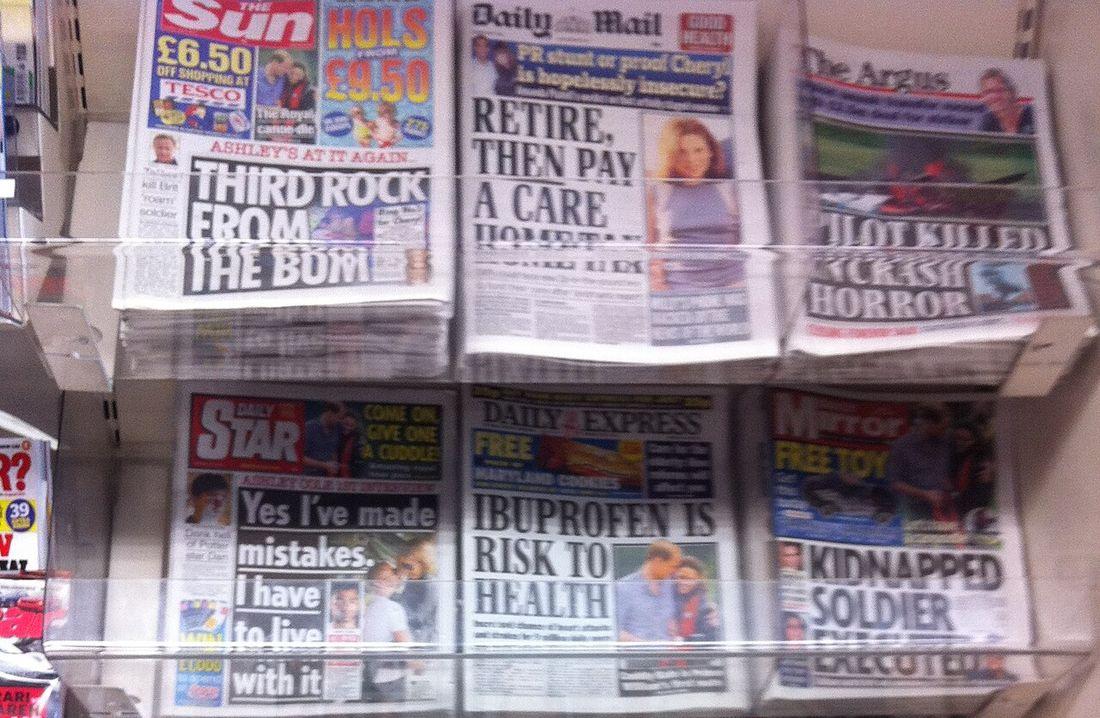 British tabloid newspapers on a shop rack, the Daily Mail in the top row, on 5 July 2011, the week the phone-hacking scandal broke