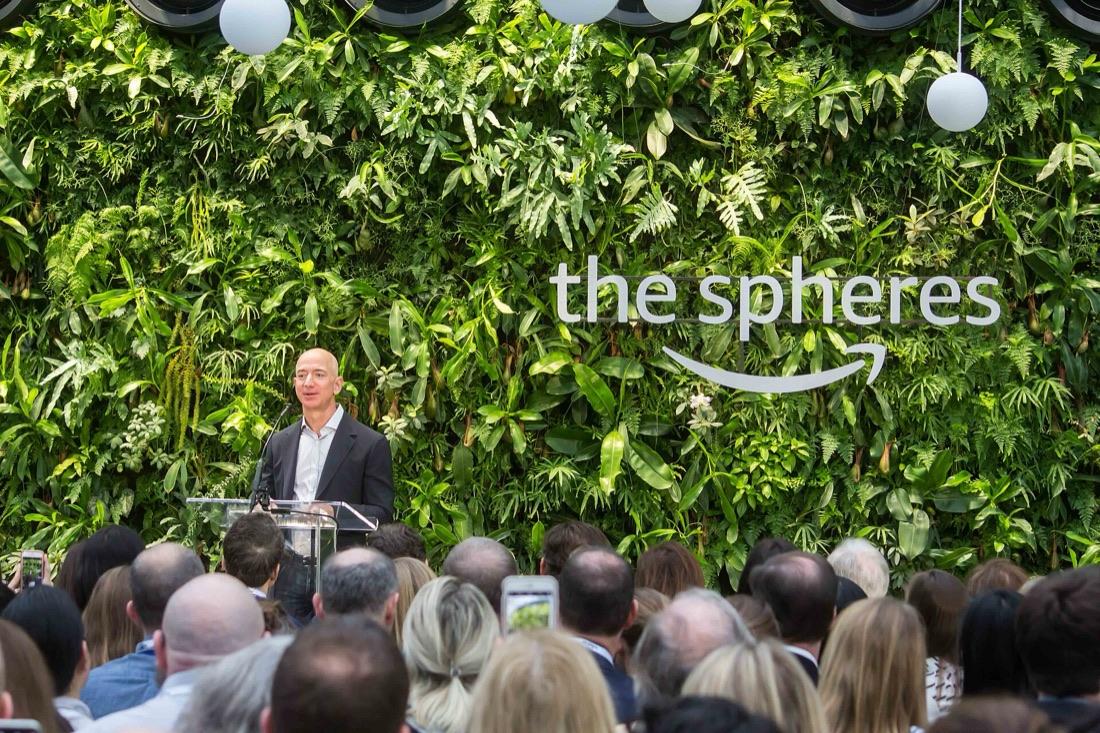 Jeff Bezos at a lectern before a living wall of plants at the opening of the Amazon Spheres in Seattle, 2018