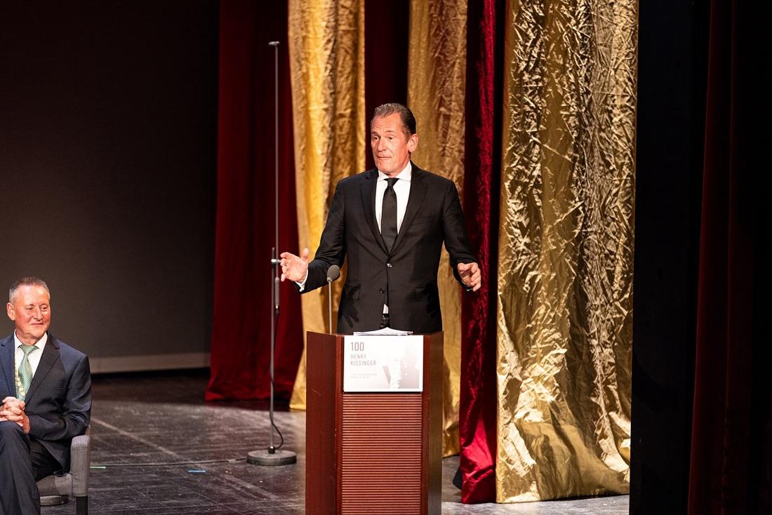 Mathias Döpfner speaking at a lectern on a stage with gold and red curtains, Fürth, June 2023