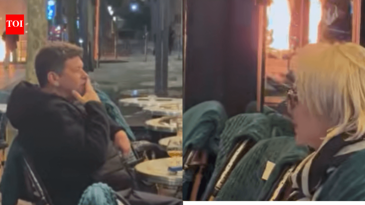 Couple Drinks Cocktails Near Arc de Triomphe as Protests Burn in Paris