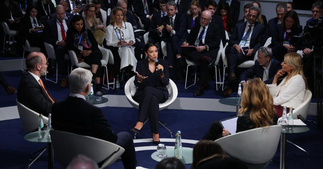 Ocasio-Cortez Offers a Working-Class Vision in Munich, With Some Stumbles