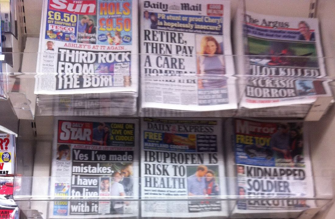 British tabloid newspapers on a shop rack, the Daily Mail in the top row, on 5 July 2011, the week the phone-hacking scandal broke